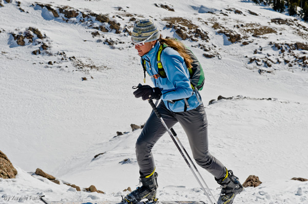 Janelle Smiley climbing on skis.