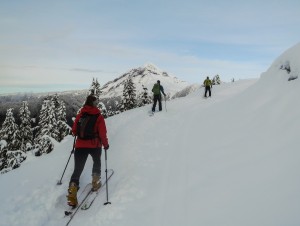 Skinning on the upper road with Garibaldi and Atwell Peaks in the background.